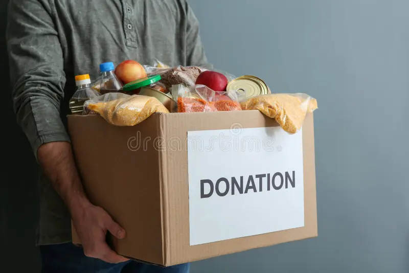 man holding donation box food gray background closeup 141599261